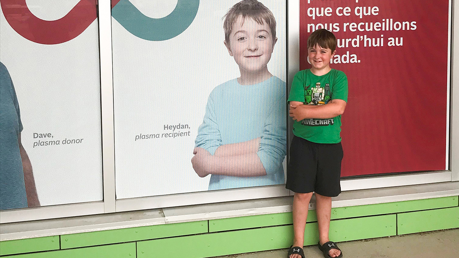 Image of Heydan Morrison standing in front of a donor centre with a green shirt pictured beside himself on the window silk