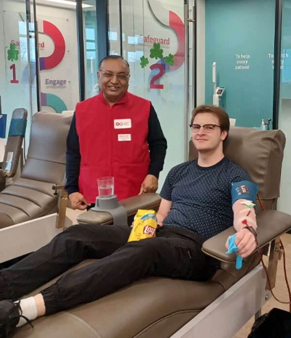 man standing by donor on a donation bed