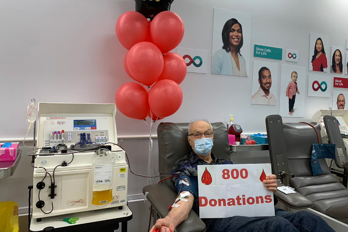 Allan Muir sitting in a donation chair donating plasma for his 800th donation.