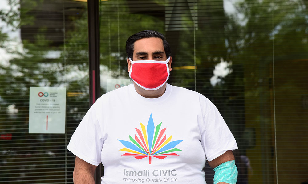 Blood donor stands outside of a donor centre