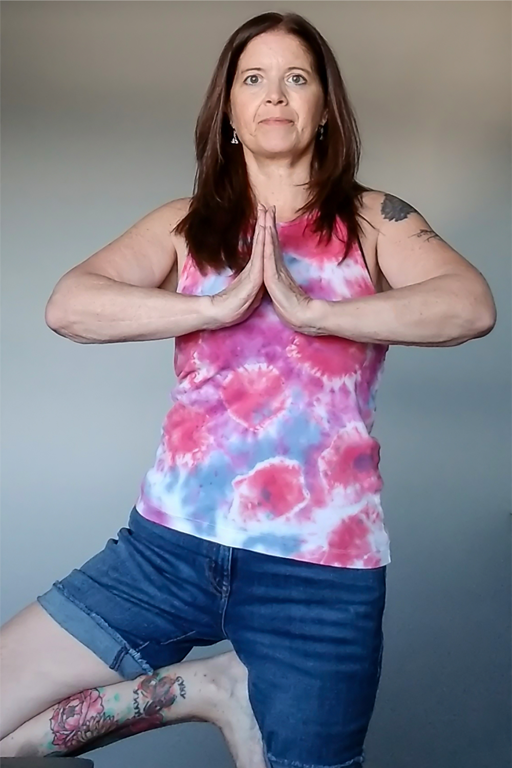 Image of lifesaving kidney recipient Linda Paul doing a yoga position standing up.