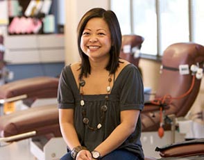 Jade - Blood Recipient Smiling woman sitting in a Blood Donor Clinic