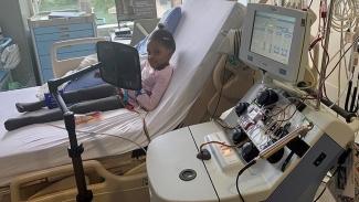 Aaliyah Mchopanga receiving red cell treatment sitting hospital bed 
