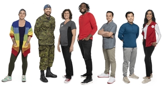 A group of people, all smiling, standing together on a white background.