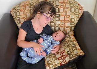 Chloe Morrell holds her newborn brother, Connor. Connor’s mother donated his umbilical cord blood to Canadian Blood Services’ Cord Blood Bank.