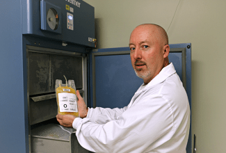 Craig Jenkins, senior manager of product and process development, removes a unit of plasma from a freezer