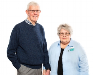 Loreen Hardy-Ramey, a woman in her eighties, stands beside her husband Noel. 