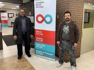 Mohammad Alawi, right, was recruited by longtime Canadian Blood Services volunteer Abdelsalam Abugharara, left, to give blood April 2, 2020. 