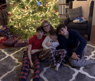 Image of Ty with his mom and two brothers at Christmas.