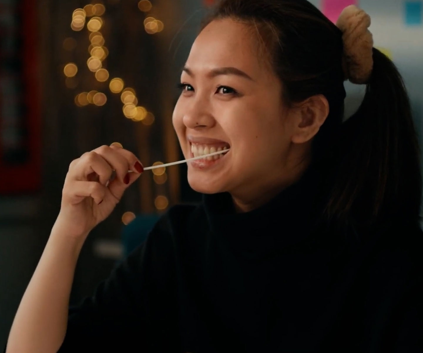 Young woman putting a swab in mouth