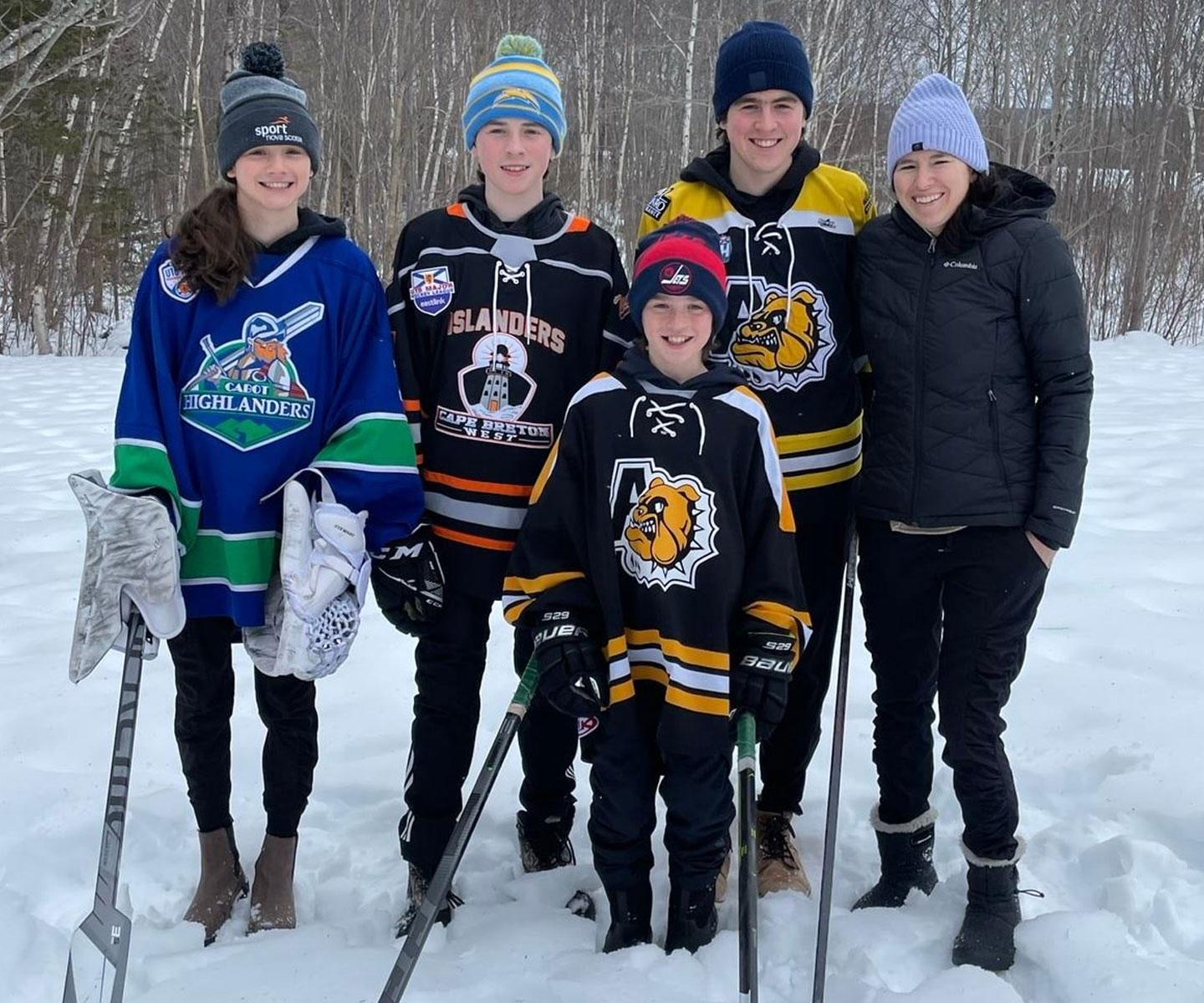 Gail Stewart outside with her four kids wearing hockey gear