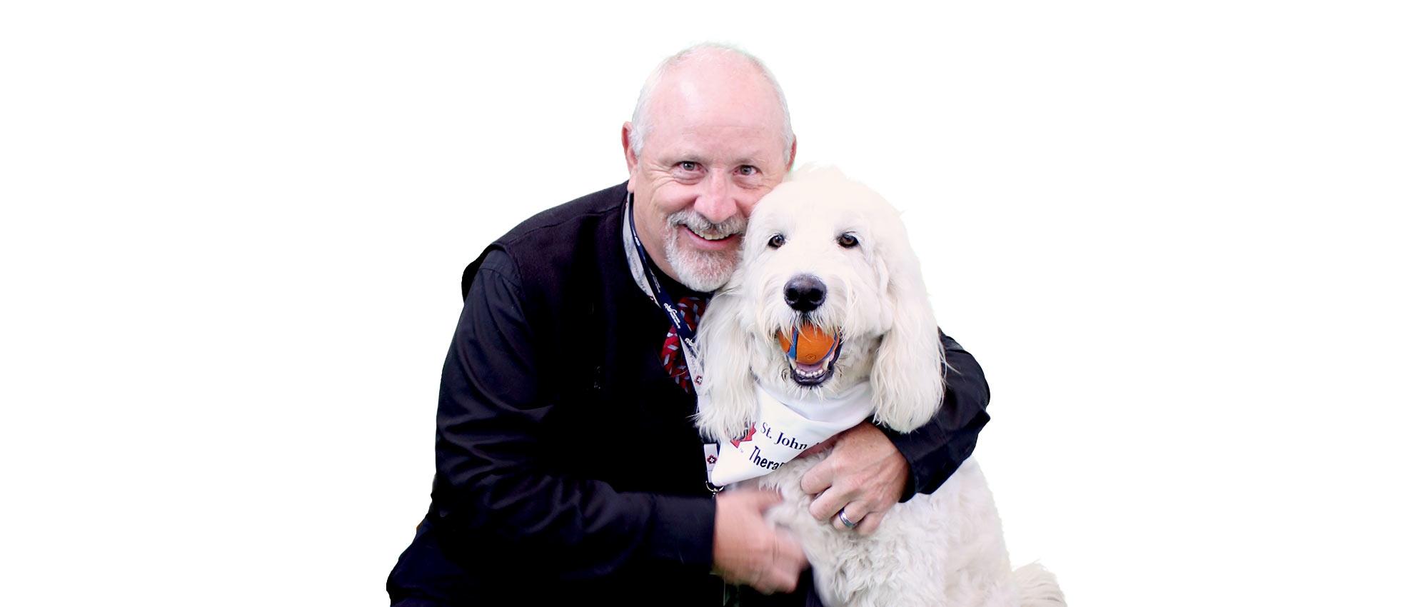A therapy dog with his male handler