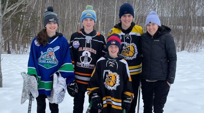 Gail Stewart outside with her four kids wearing hockey gear