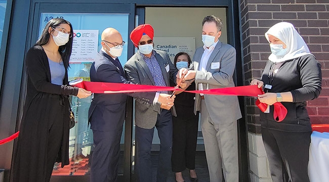 Canadian Blood Services ribbon-cutting with donor at new plasma donor centre in Brampton, Ont.